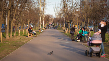 Spacious spring square with people for a walk in a modern city