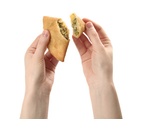 Woman holding fresh cut samosa on white background, closeup