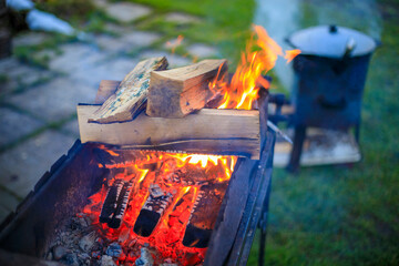 Cooking in a cauldron on the fire. Picnic outdoors in summer.