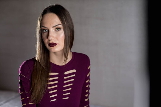 Sexy Caucasian Woman Wearing A Bordeaux Color Lipstick And A Tight Dress