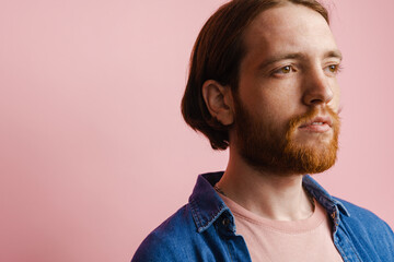 Fototapeta premium Young ginger man with beard posing and looking aside