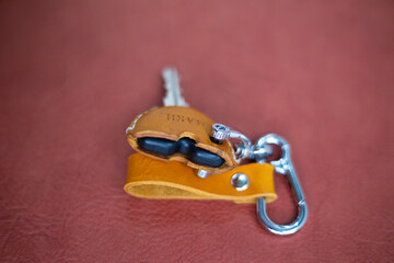 Genuine keychain leather crafts working on red leather background