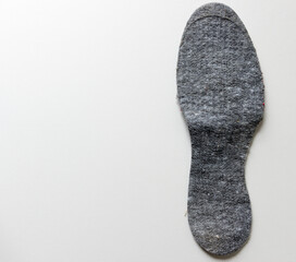 worn felt insole isolated on white
