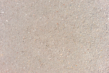 The concrete with many pebbles.