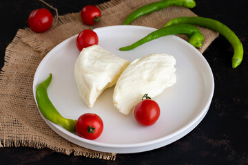 Goat cheese on dark background.