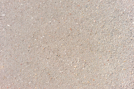 The concrete with many pebbles.