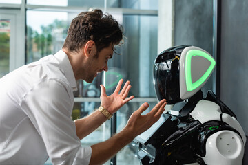 excited businessman showing wow gesture near humanoid robot in office