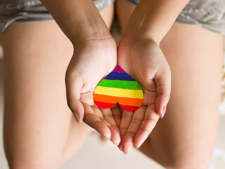 Rainbow color heart on hand for lgbtq community.