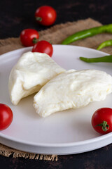 Goat cheese on dark background.