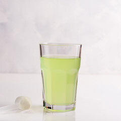 Vitaminized drink for athletes in a glass on a white background