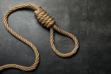 Obraz premium Rope noose with knot on grey table, top view. Space for text