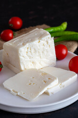 Sliced feta cheese on dark background