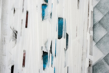 stack of paper in fan or step arrangement with ink spots or markings on white - backgrounds