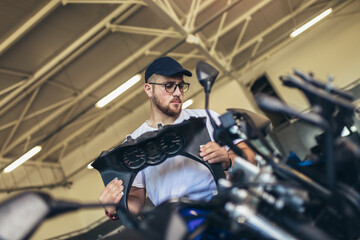 Fototapeta na wymiar Professional motorcycle mechanic working in bike repair service