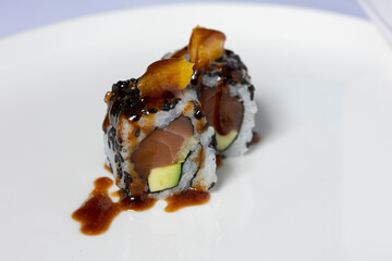 Steak tartare sushi roll served on a white plate