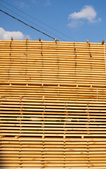 Storage of piles of wooden boards on the sawmill. Boards are stacked in a carpentry shop. Sawing drying and marketing of wood. Pine lumber for furniture production, construction. Lumber Industry.