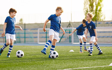 Obraz premium Boys in Blue Soccer Jersey Uniforms. Kids on Football Training
