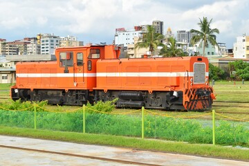 Orange diesel engine trains, cargo and mass transit.