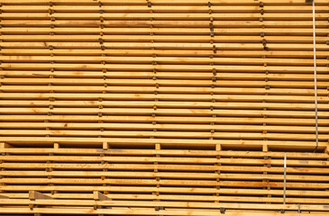 Storage of piles of wooden boards on the sawmill. Boards are stacked in a carpentry shop. Sawing drying and marketing of wood. Pine lumber for furniture production, construction. Lumber Industry.
