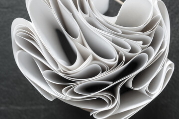 curled folded paper background - photographed from above in a flat lay style - with focus on the rim - photograph has shallow depth of field - specific focus