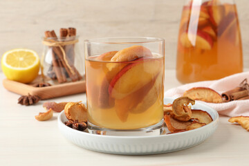 Delicious compot with dried apple slices on light wooden table
