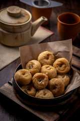 Indian traditional sweet balushahi served on a metal plate on wooden background