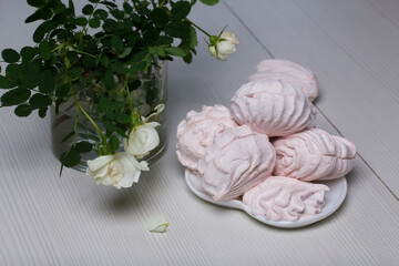 Homemade marshmallows on a plate. Marshmallows of different shapes, classic and heart-shaped....