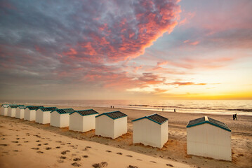 Beachhouses at the beach on Texel island in the Netherlands during sun set.