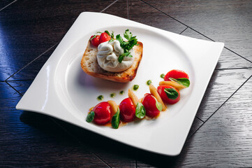 Salad with Tomatoes, honey pear and Burrata cheese with basil and olive oil on wooden background