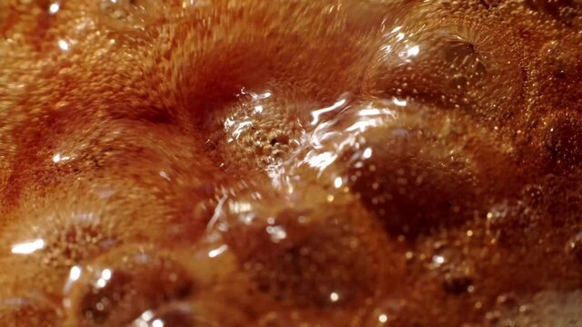 Macro shot of liquid caramel boiling