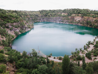 overhead top view of flooded mine lake with blue water