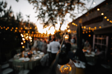 Fototapeta na wymiar light bulbs decorate the site for an outdoor wedding
