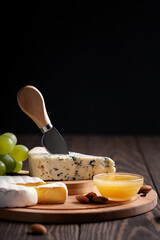 Camembert and gorgonzola with green grape, nuts,  honey