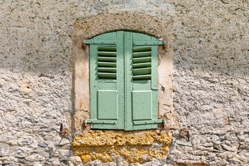 Very old shuttered farmhouse window in the French Alps