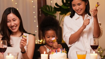 Asian couple celebrate birthday party with cake together at home. LGBTQ lover have a romantic moments together. Same-sex marriage and LGBT couple relationship concept.