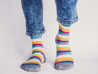 Men's legs and bright socks. Without shoes. Close-up. Style, beauty and elegance concept