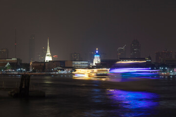 Chao Phraya River at night, crossed by different boats for tourists and merchandise transport