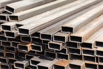 metal rectangular profile in a stack, metal pipes of rectangular cross-section on the site of a building materials store, metal building materials