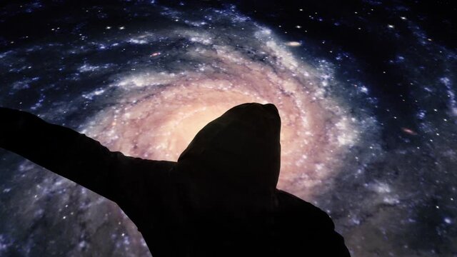 A boxer training (a black silhouette wearing a hoodie and thowing punches), under a surreal background of rotating galaxies.
