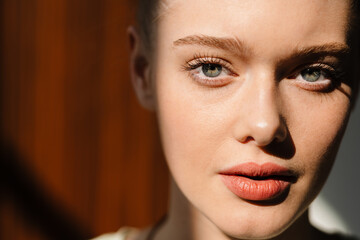 Young blonde white woman posing and looking at camera indoors