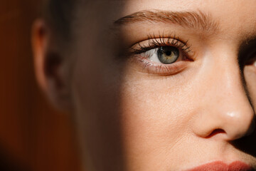 Young blonde white woman posing and looking aside indoors