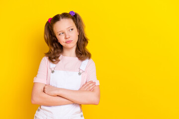 Portrait of attractive suspicious arrogant girl folded arms looking aside copy space isolated over...