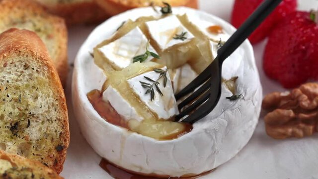 Baked Camembert or Brie cheese with thyme and syrup.