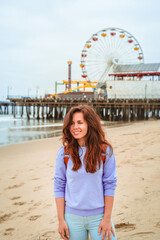 Beautiful woman walks on Santa Monica beach in Los Angeles