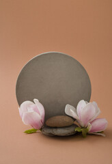 minimalist mockup with concrete shapes and magnolia blooming