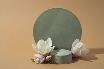 minimalist mockup with concrete shapes and magnolia blooming