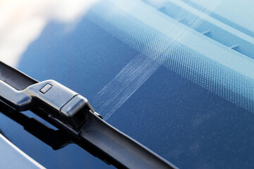Scratch on car windshield from cleaning worn out wipers, close-up