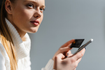 Close up of a young blonde woman shopping online