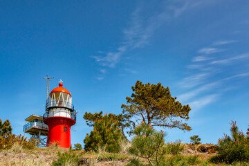 Red lighthouse on a dune at Vlieland island in the Netherlands.