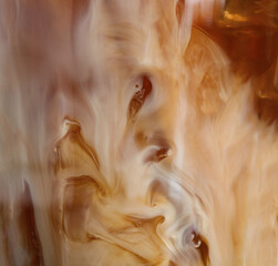Glass with cold coffee and milk, closeup